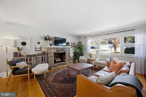 a living room with furniture fireplace and flat screen tv
