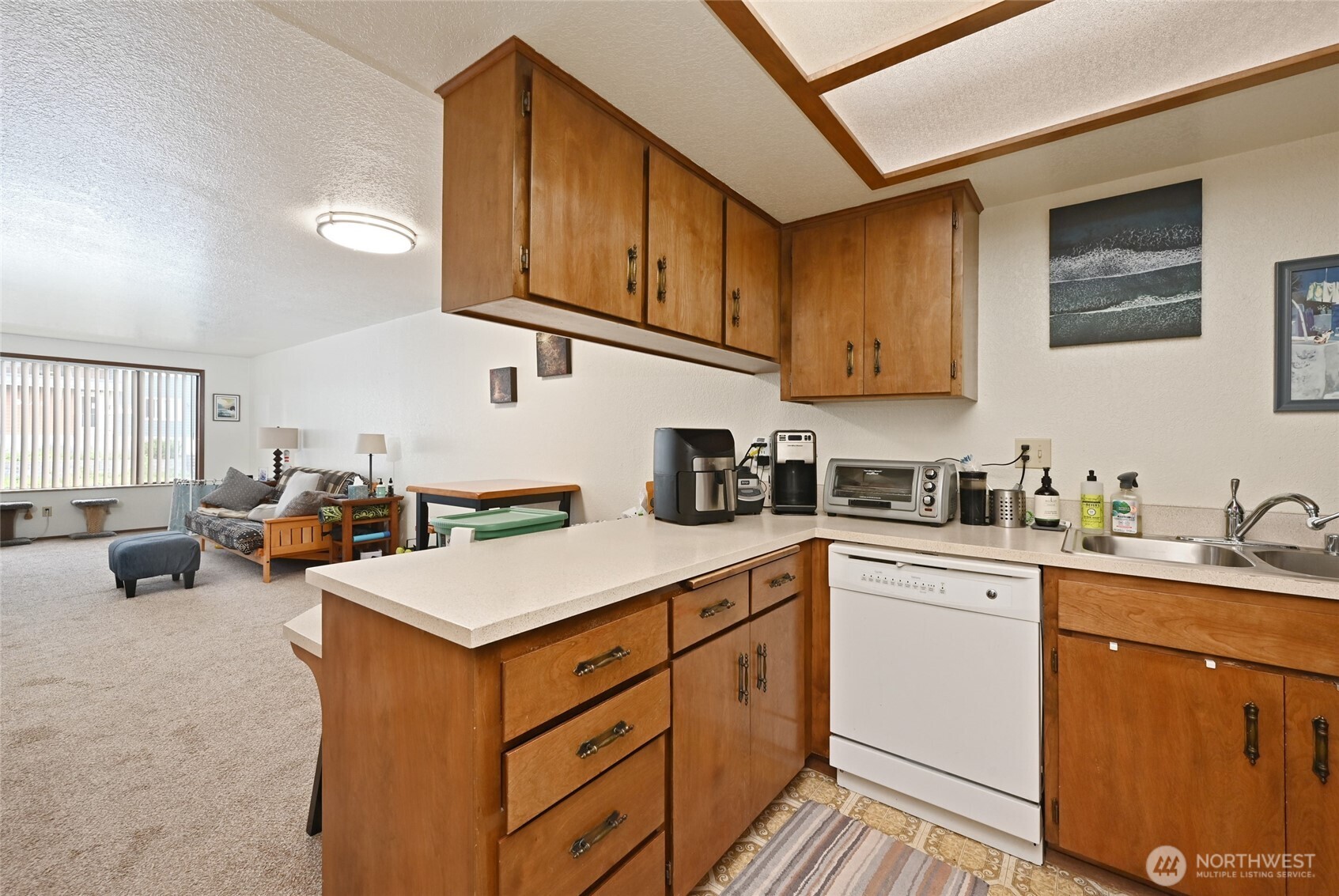 3323 Oakes Avenue, Unit 112 Everett, WA 98201 - Photo 21 of 31 a kitchen with a sink dishwasher and white cabinets with wooden floor