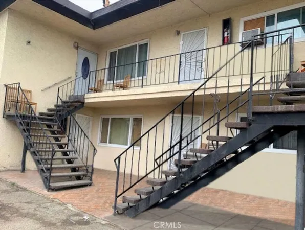 a view of balcony with wooden floor and white walls