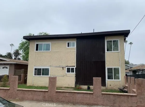 a house that has a tree in front of it