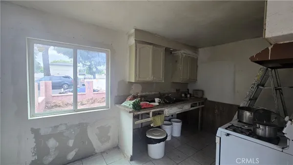 a room with furniture a rug and a window