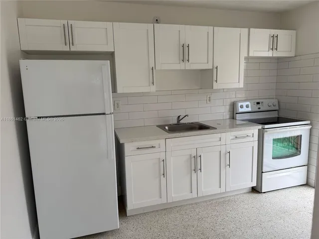 a white refrigerator freezer sitting inside of a kitchen
