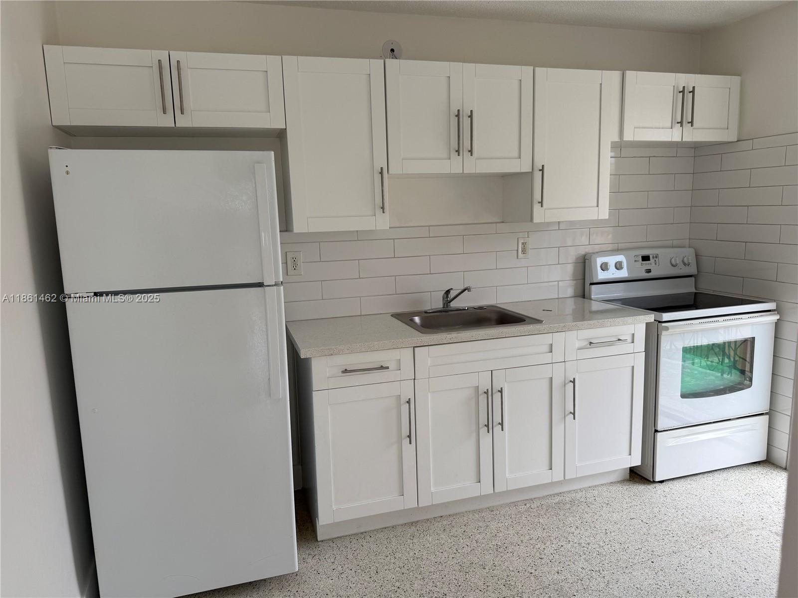a white refrigerator freezer sitting inside of a kitchen