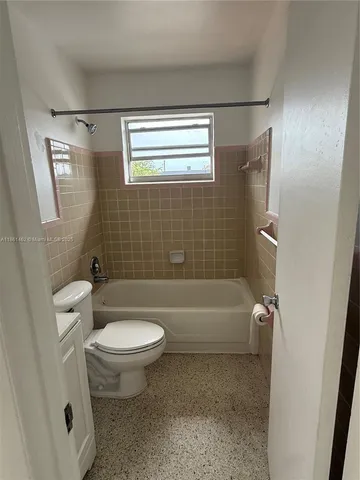 a bathroom with a bathtub toilet and sink