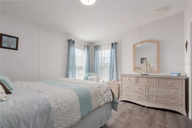 a bedroom with a large bed and a dresser