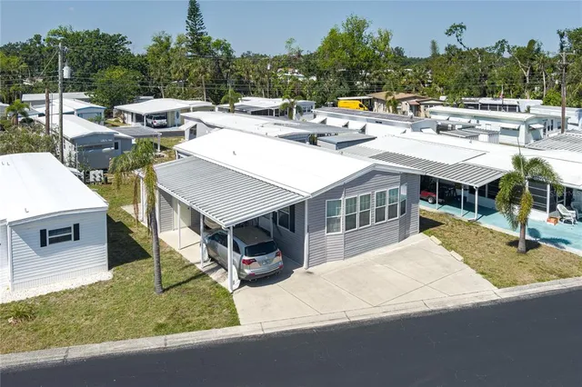 a view of a house with pool and chairs