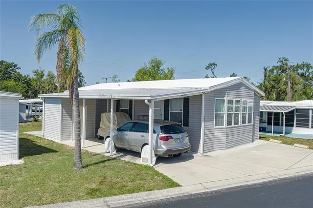 a view of a house with a patio and a yard