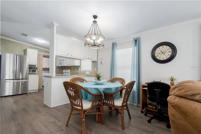 a view of a dining room with furniture and a clock