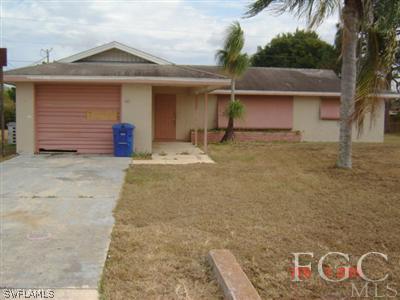 108 Florida Road Lehigh Acres, FL 33936 - Photo 1 of 10 a front view of a house with parking