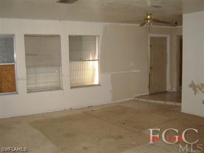 108 Florida Road Lehigh Acres, FL 33936 - Photo 4 of 10 an empty room with windows