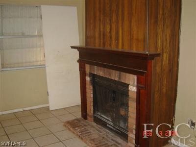 108 Florida Road Lehigh Acres, FL 33936 - Photo 7 of 10 a stove top oven sitting inside of a room