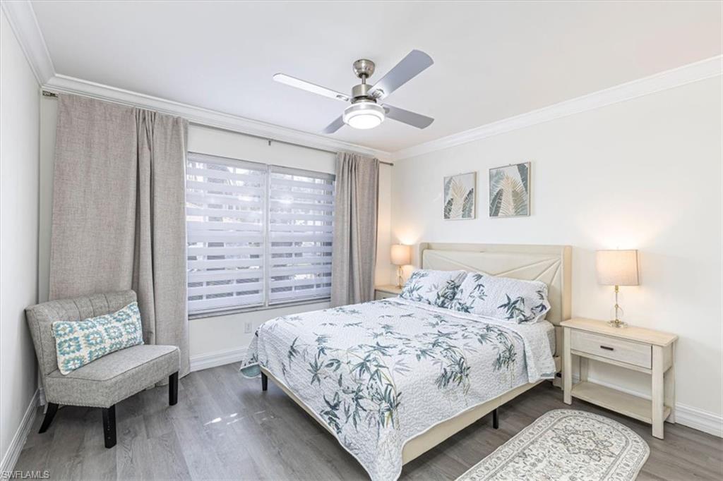 1630 Triangle Palm Terrace Naples, FL 34119 - Photo 14 of 24 a bedroom with a bed and a couch
