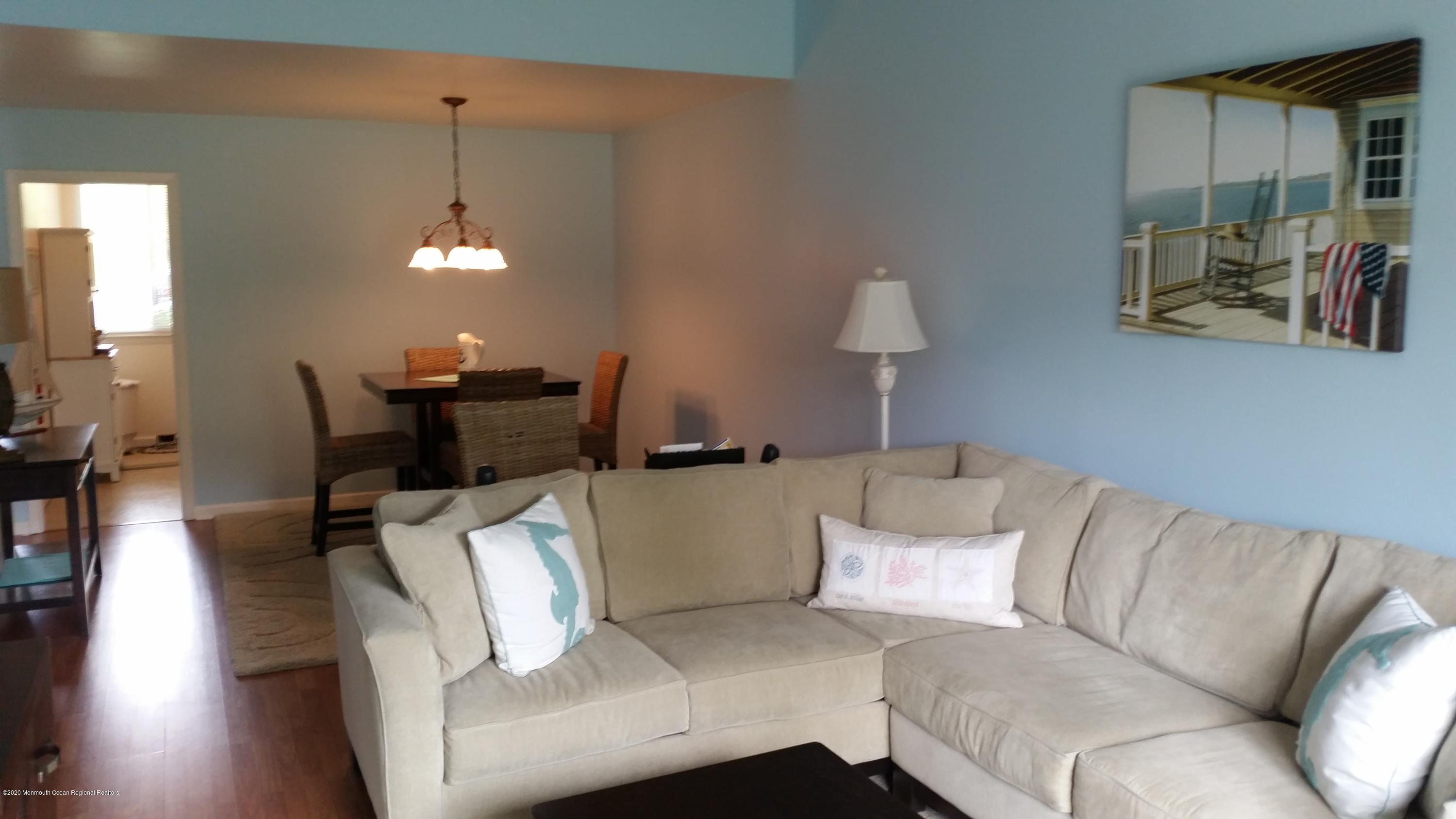 14 Carol Court Tinton Falls, NJ 07724 - Photo 2 of 13 a living room with furniture and a lamp