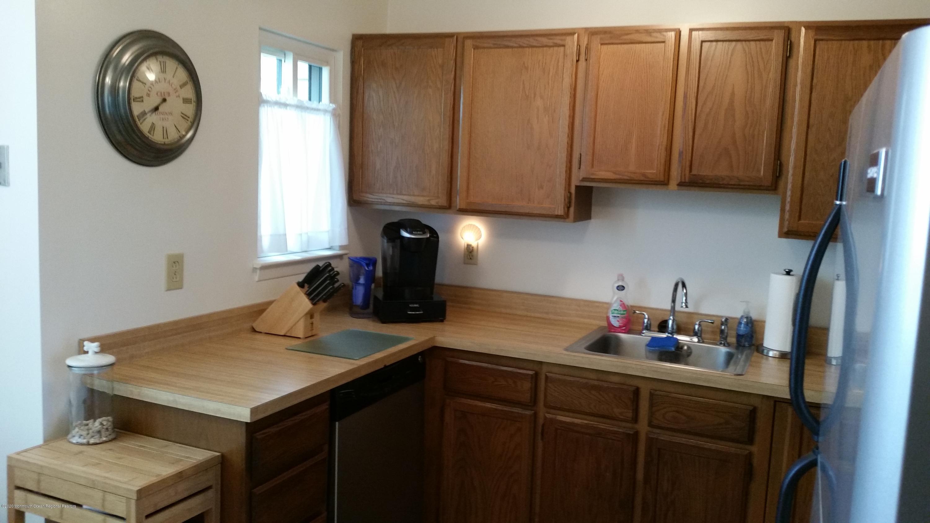 14 Carol Court Tinton Falls, NJ 07724 - Photo 4 of 13 a kitchen with a sink cabinets and a window