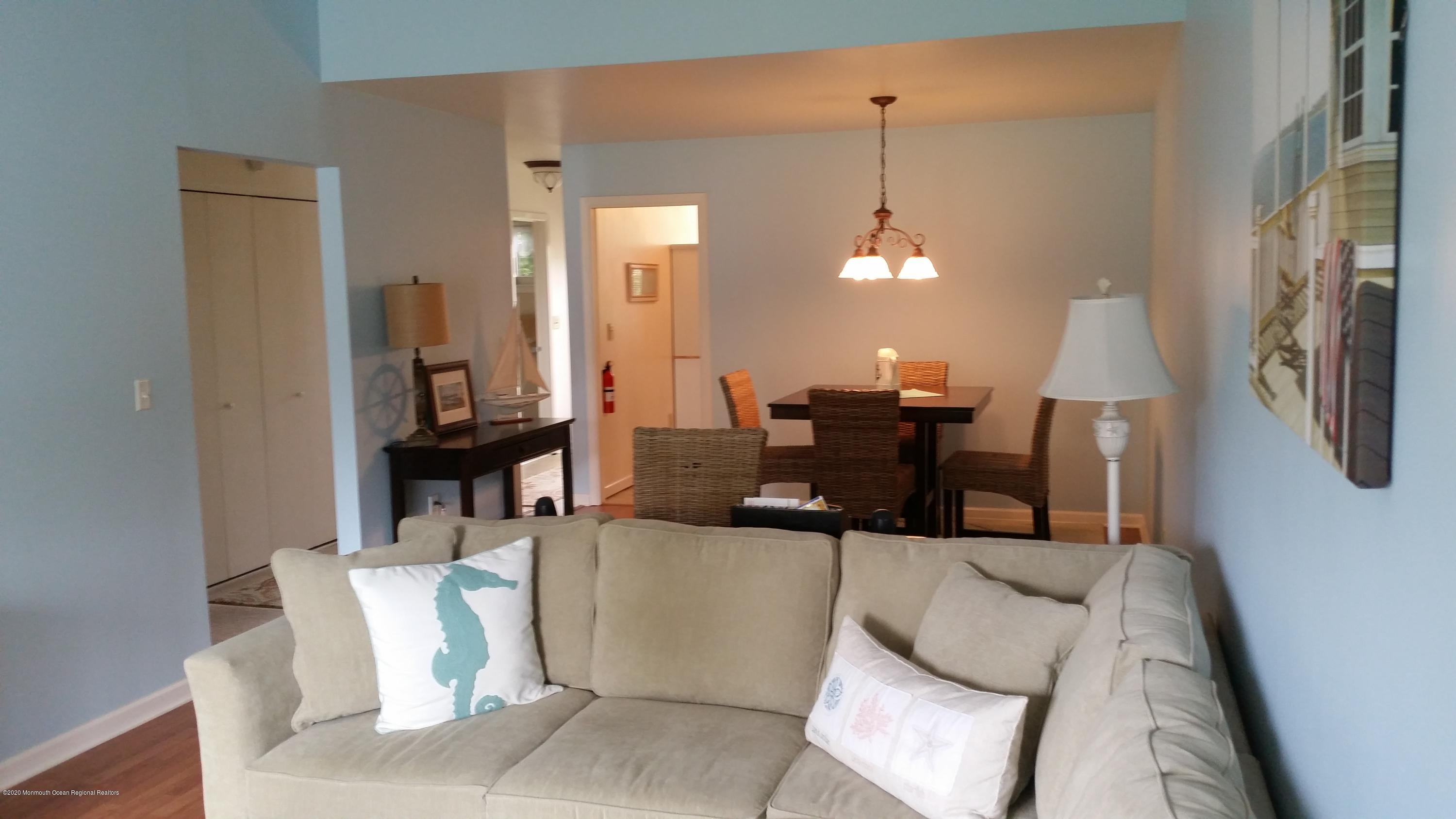 14 Carol Court Tinton Falls, NJ 07724 - Photo 6 of 13 a living room with furniture and a chandelier