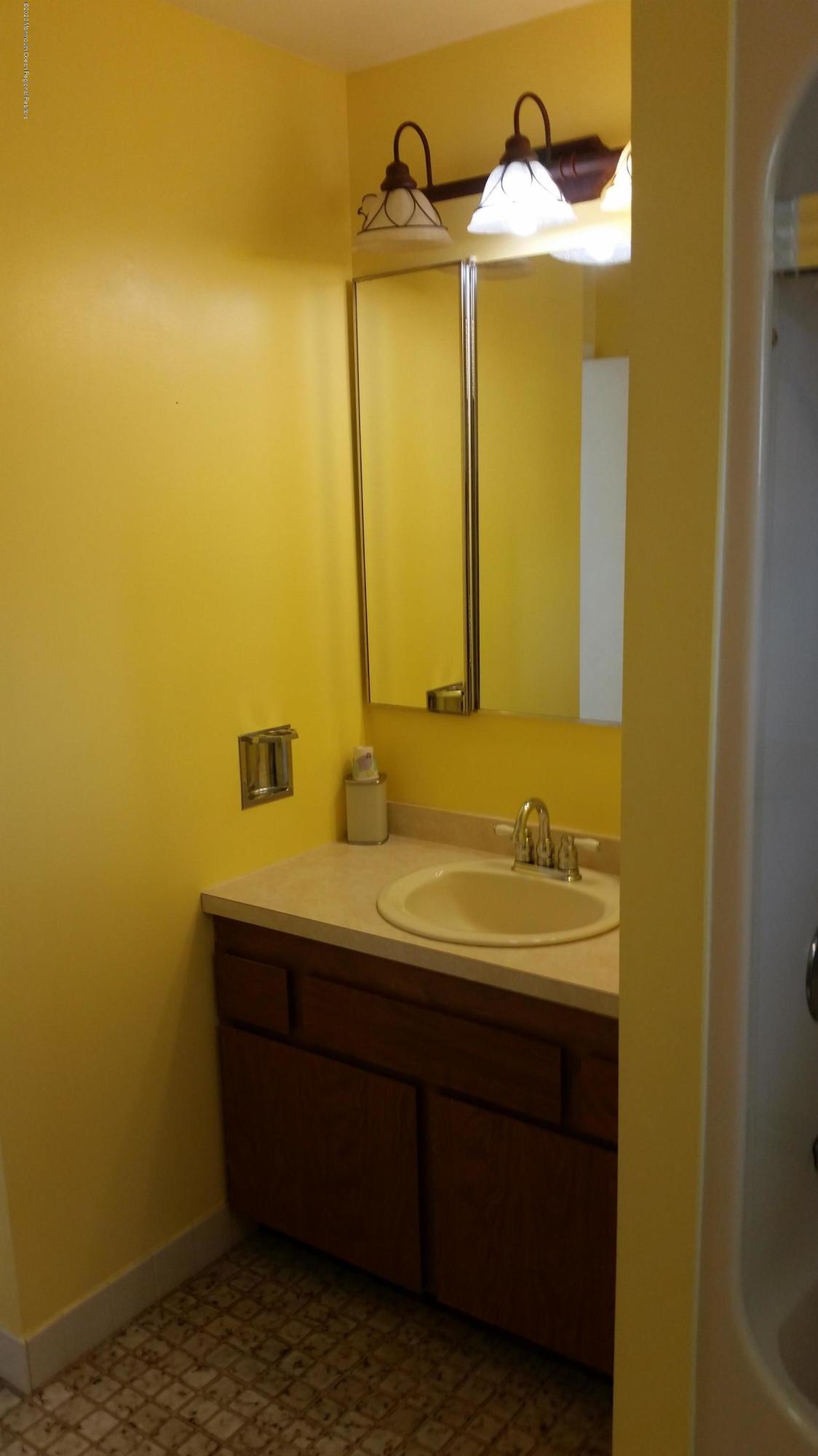 14 Carol Court Tinton Falls, NJ 07724 - Photo 8 of 13 a bathroom with a sink and a mirror
