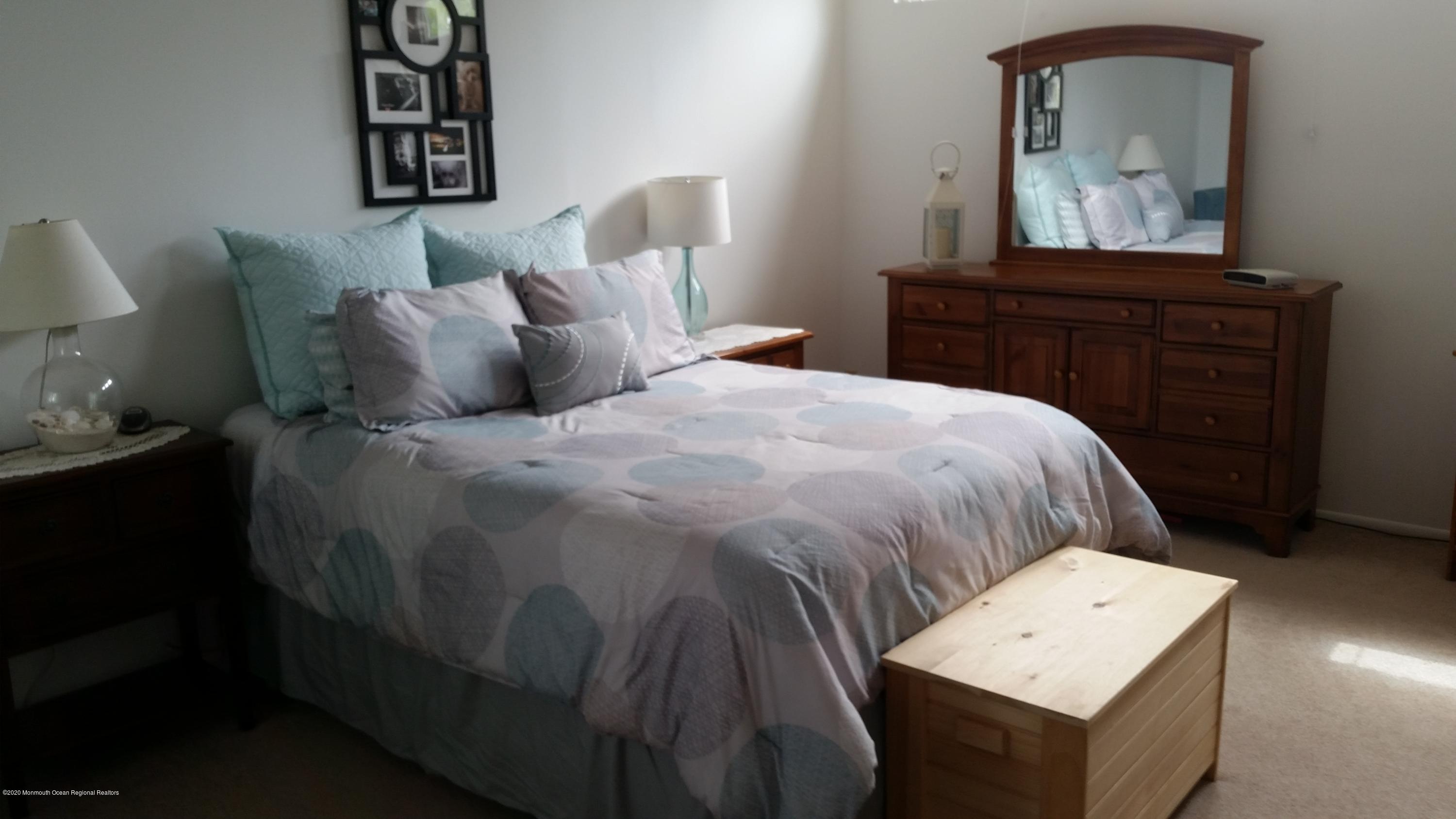 14 Carol Court Tinton Falls, NJ 07724 - Photo 9 of 13 a bedroom with a bed and cabinet