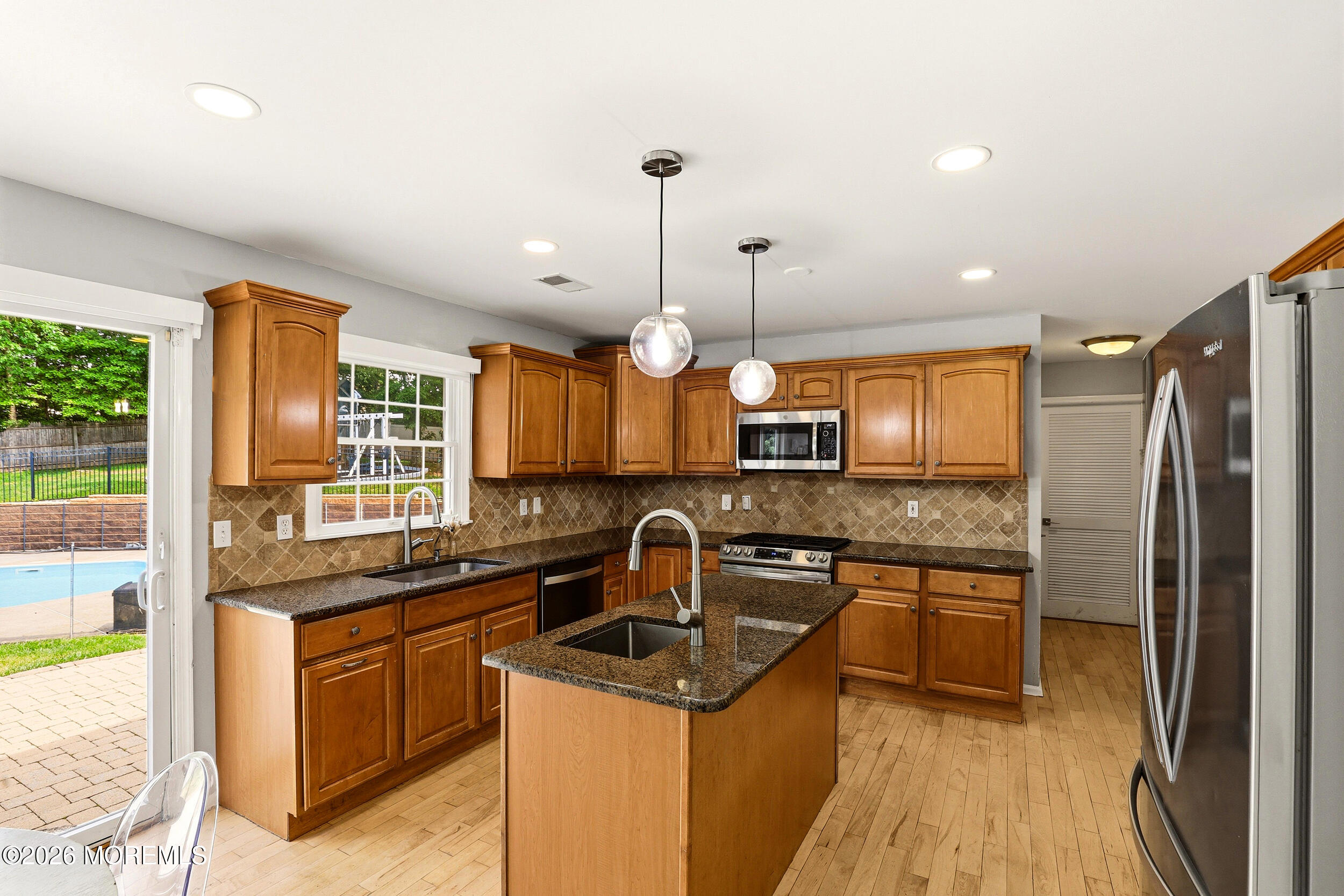2055 MacKenzie Road Toms River, NJ 08755 - Photo 15 of 56 a kitchen with a sink stove and refrigerator