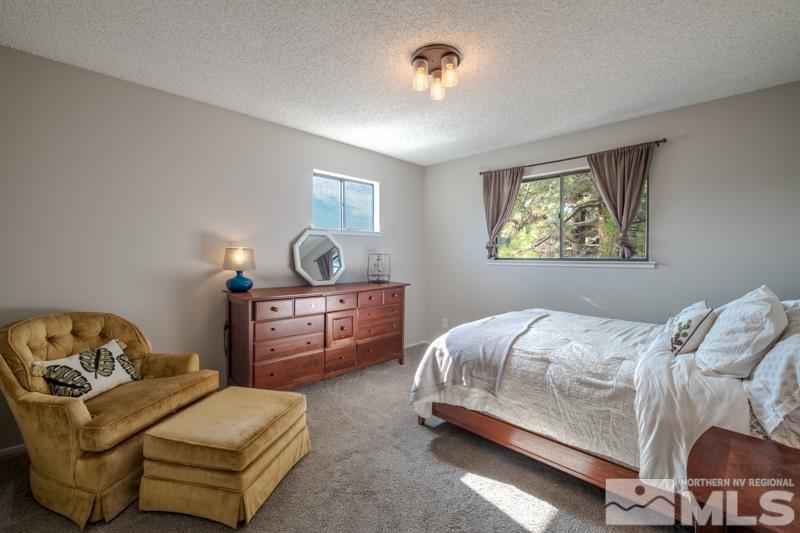 175 Greenstone Drive Reno, NV 89512 - Photo 22 of 33 a bedroom with a bed and ceiling fan