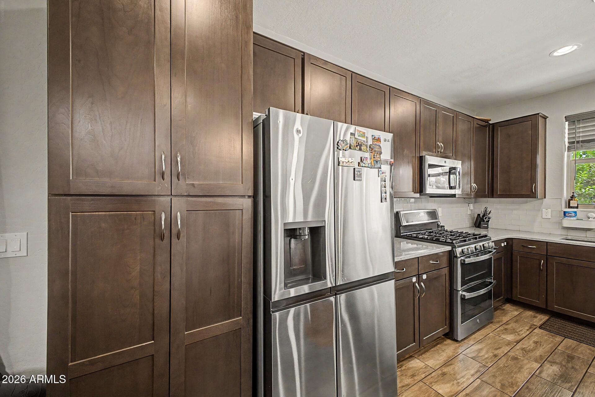 701 East Liberty Lane Gilbert, AZ 85296 - Photo 12 of 46 a kitchen with stainless steel appliances granite countertop a refrigerator and a sink