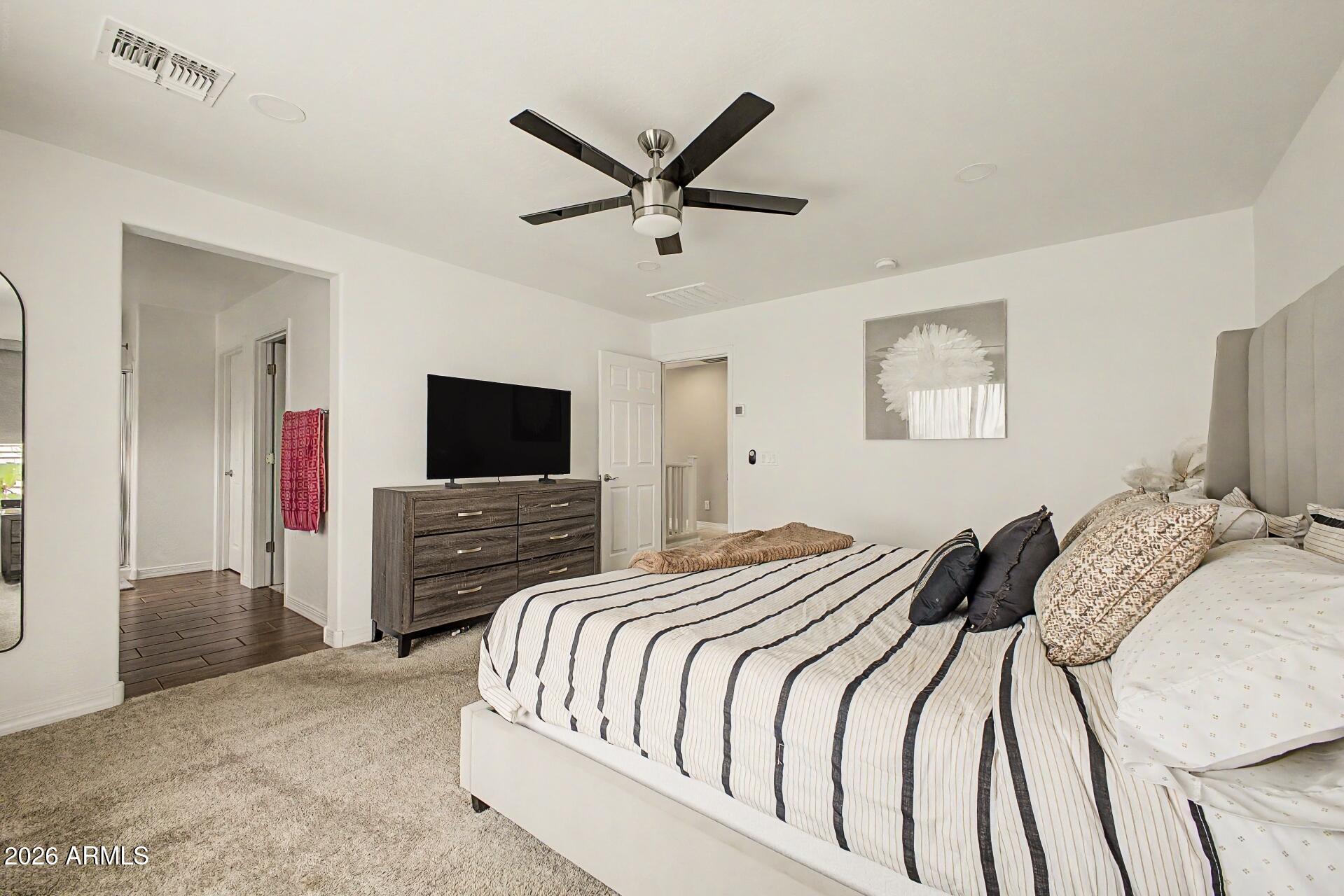 701 East Liberty Lane Gilbert, AZ 85296 - Photo 18 of 46 a bedroom with a bed and a flat screen tv