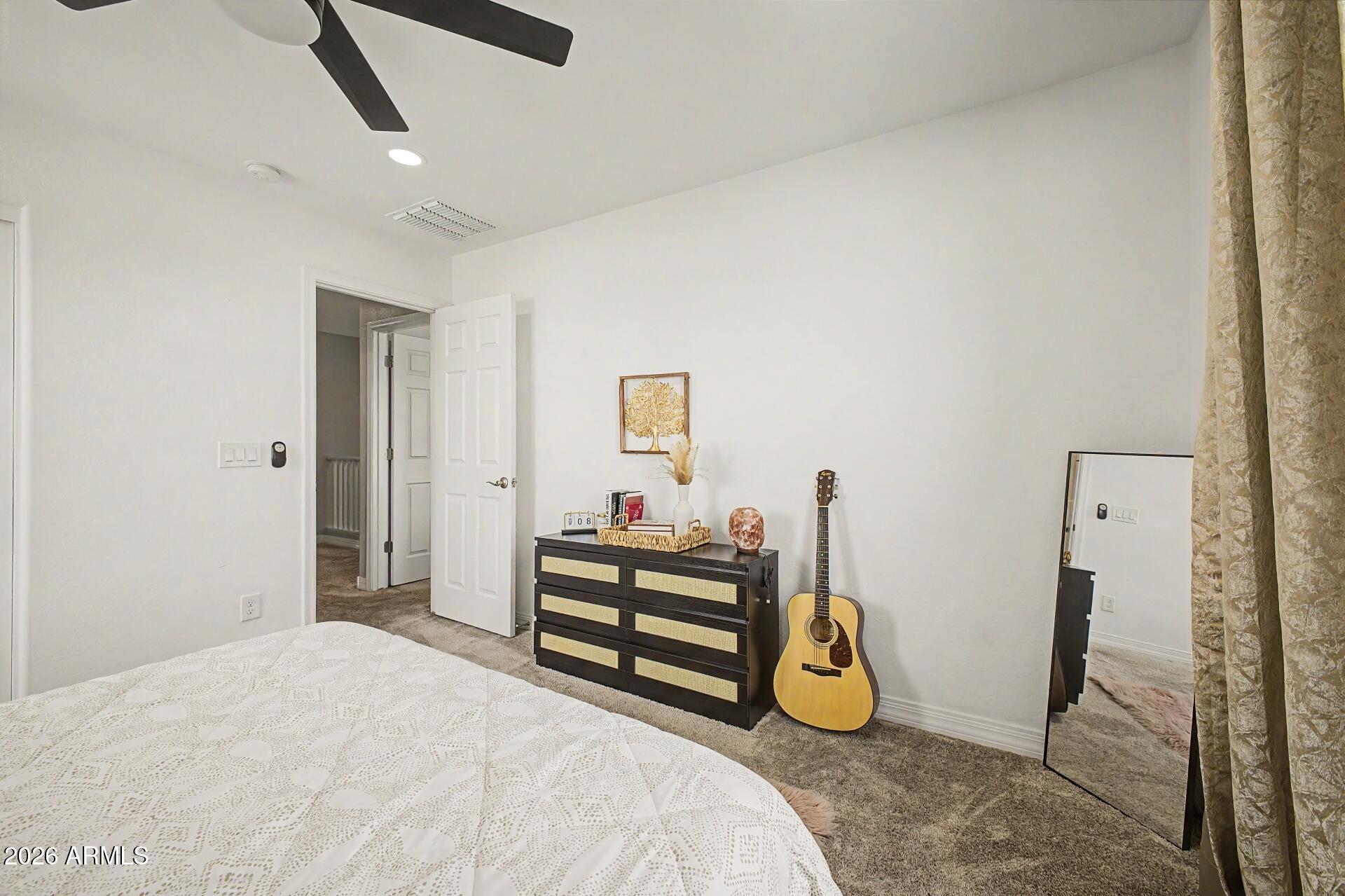 701 East Liberty Lane Gilbert, AZ 85296 - Photo 21 of 46 a bedroom with a bed and a chandelier