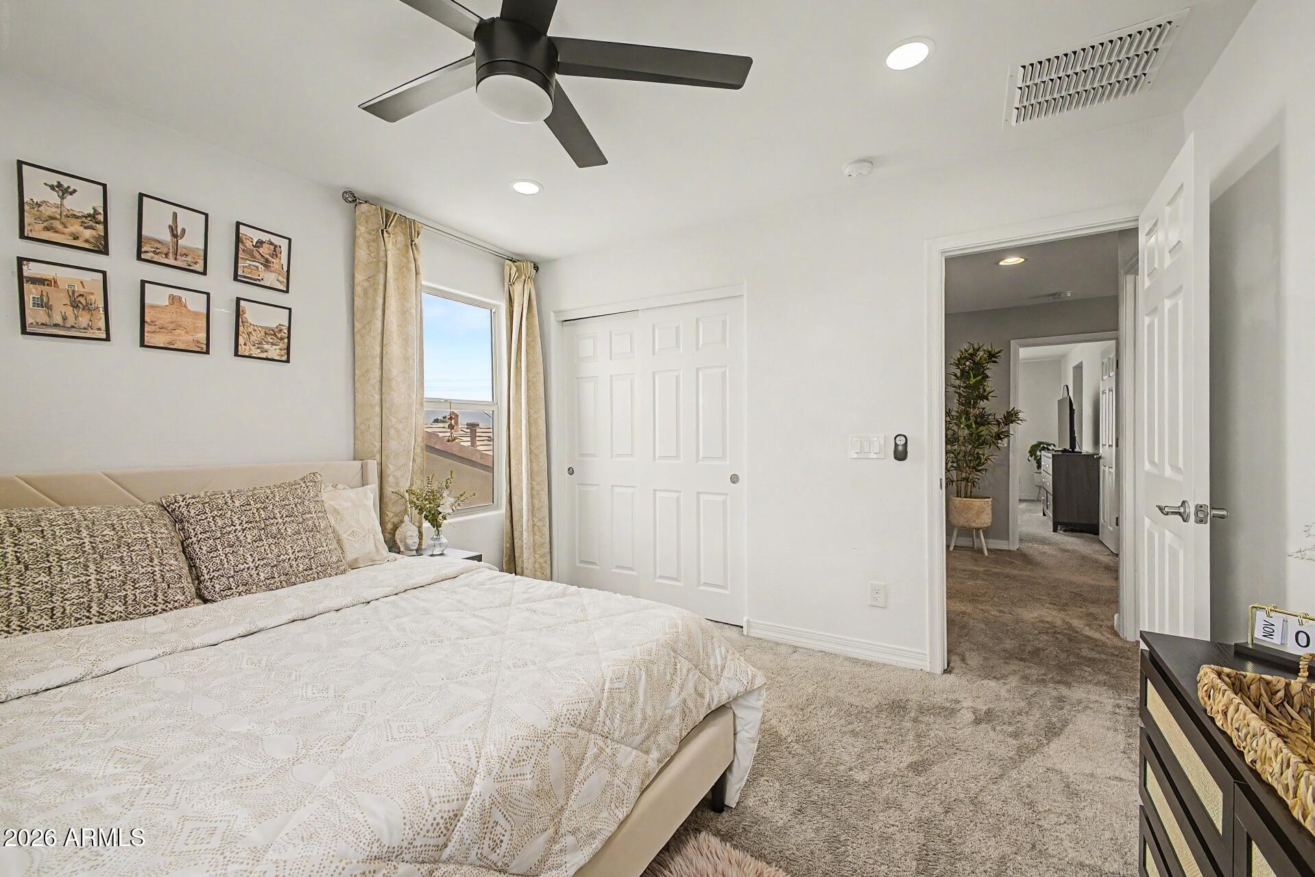 701 East Liberty Lane Gilbert, AZ 85296 - Photo 23 of 46 a bedroom with a bed and a chandelier