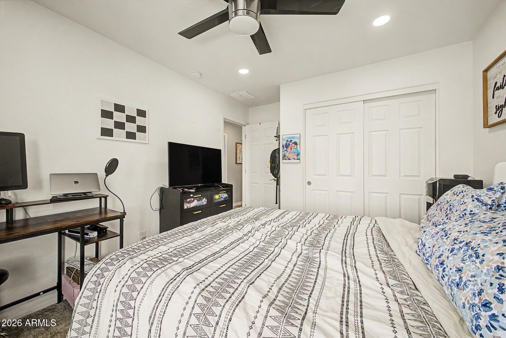 701 East Liberty Lane Gilbert, AZ 85296 - Photo 24 of 46 a bedroom with a bed and a flat screen tv