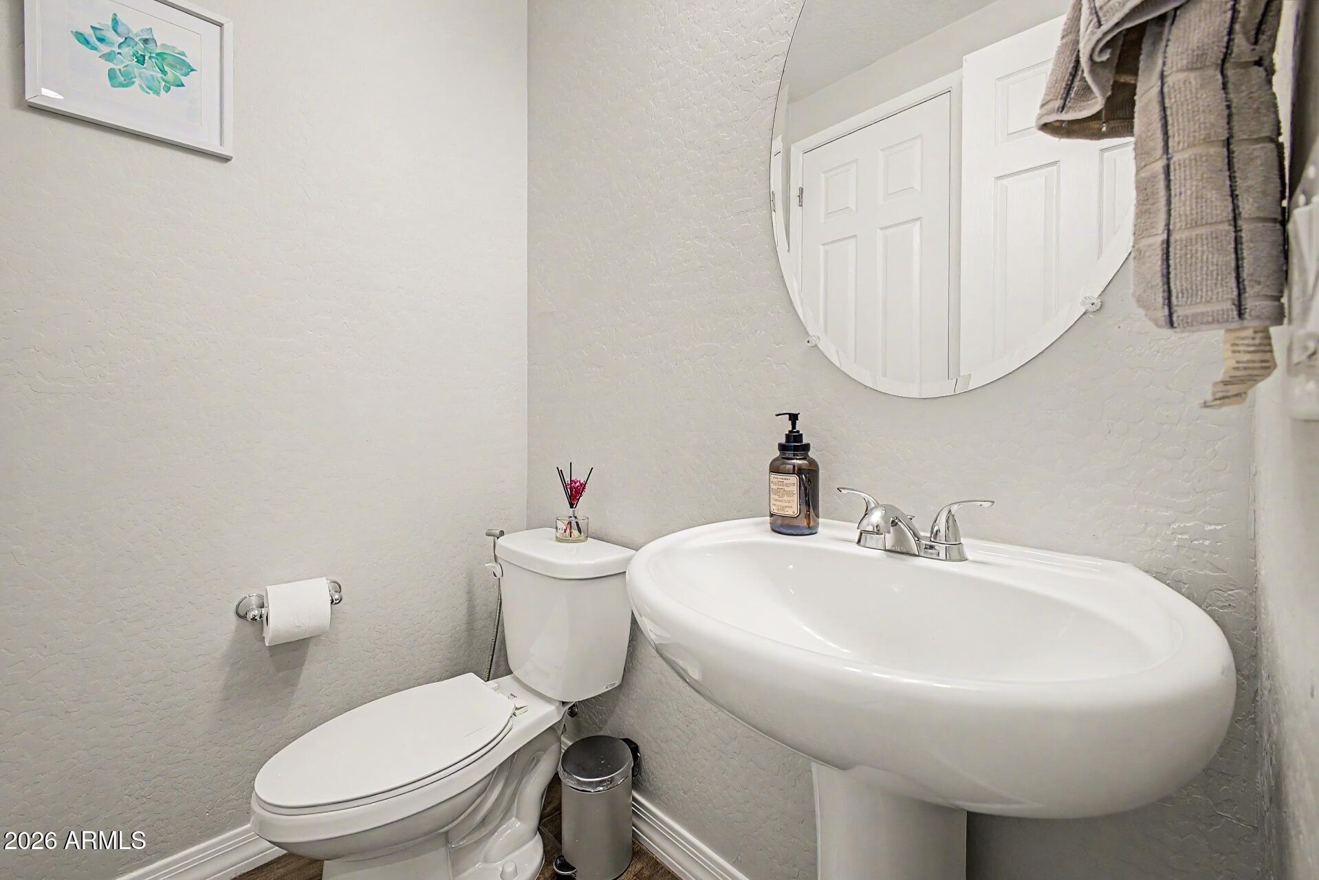701 East Liberty Lane Gilbert, AZ 85296 - Photo 25 of 46 a white toilet sitting next to a bathroom sink