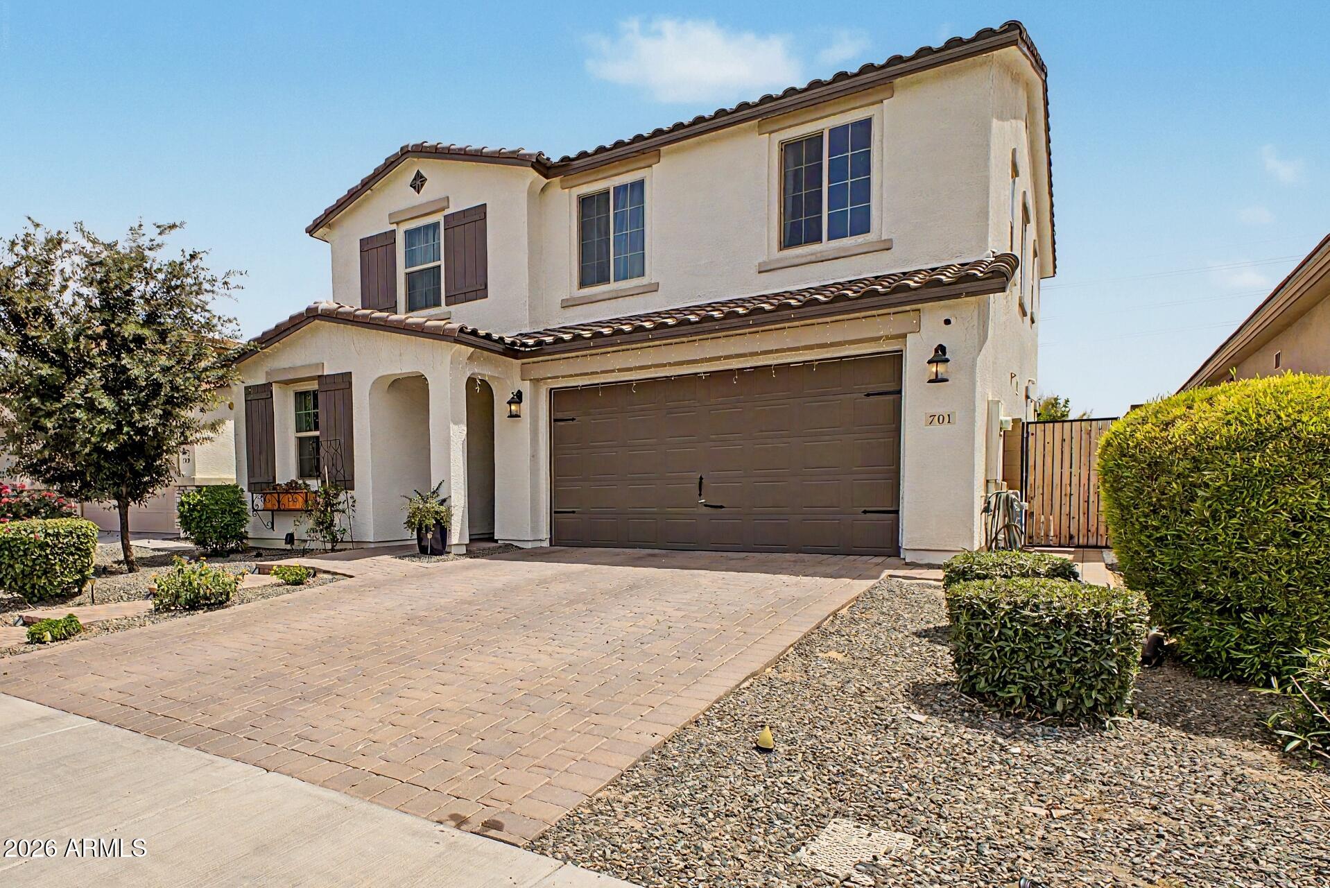 701 East Liberty Lane Gilbert, AZ 85296 - Photo 44 of 46 a front view of a house with a garden and entryway