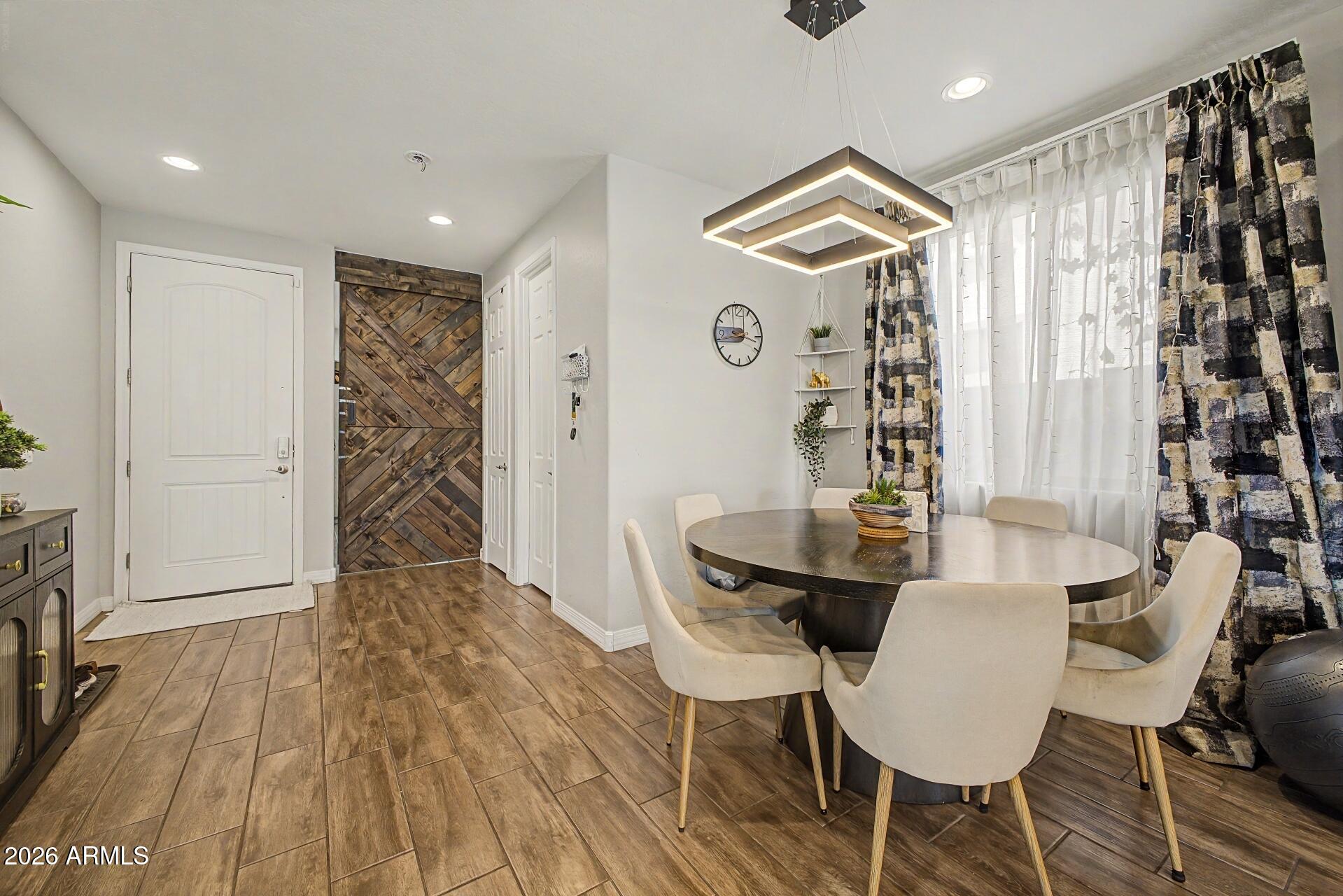 701 East Liberty Lane Gilbert, AZ 85296 - Photo 7 of 46 a view of a dining room with furniture and wooden floor