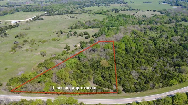 a view of a yard with wooden fence