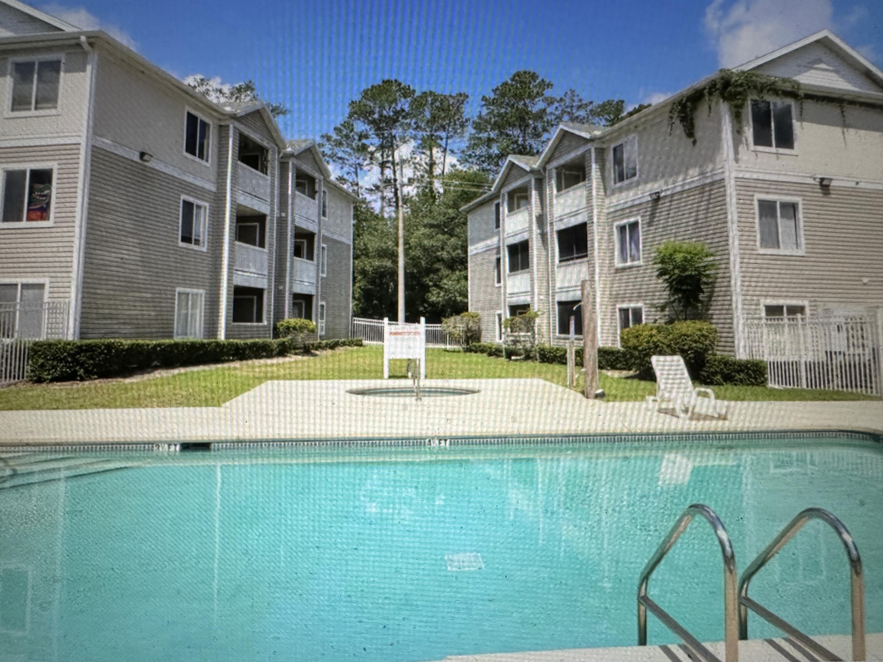 4000 Southwest 23rd Street, Unit 2201 Gainesville, FL 32608 - Photo 2 of 17 a view of a building with a swimming pool