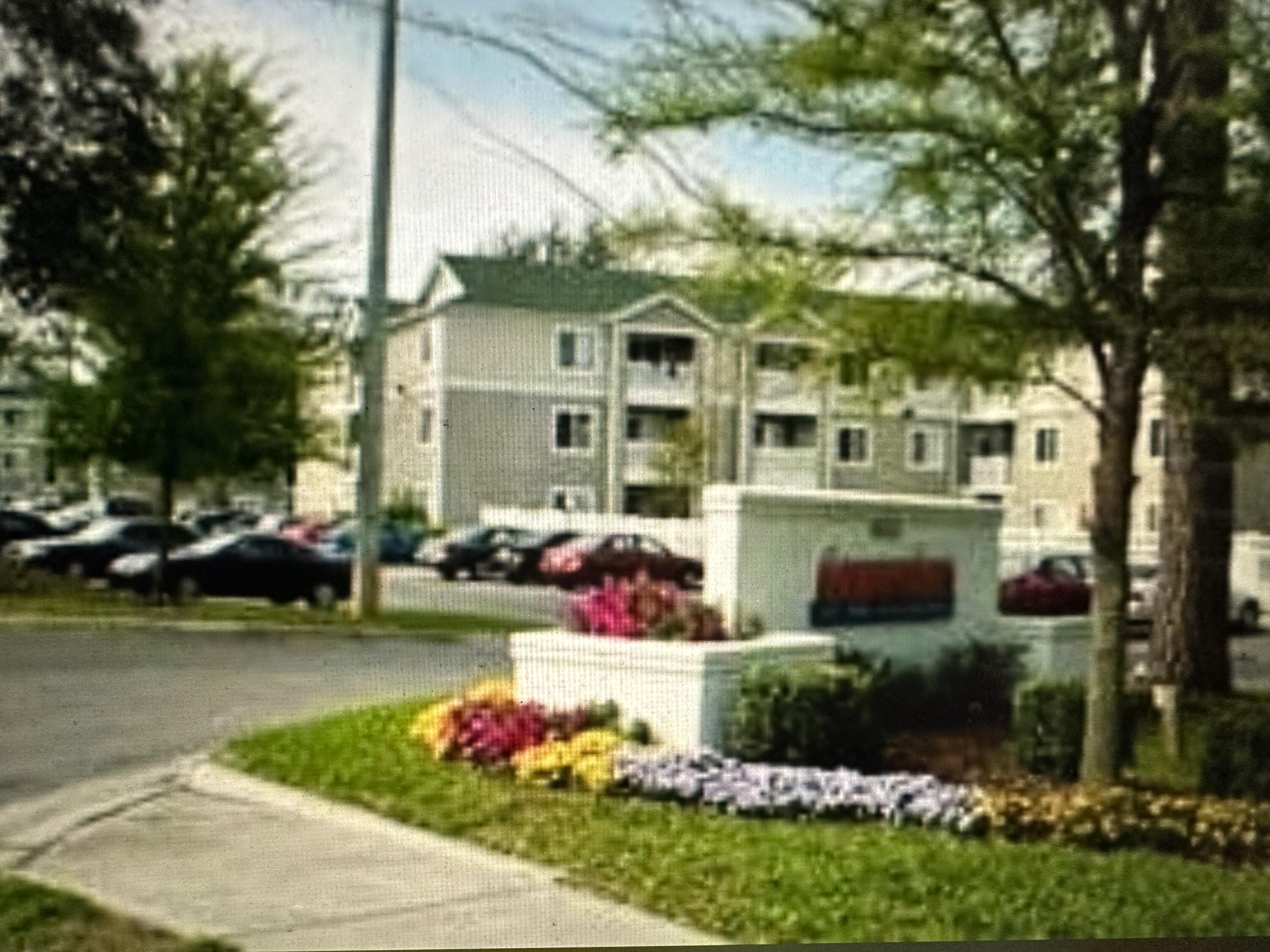 4000 Southwest 23rd Street, Unit 2201 Gainesville, FL 32608 - Photo 7 of 17 a front view of a building with garden