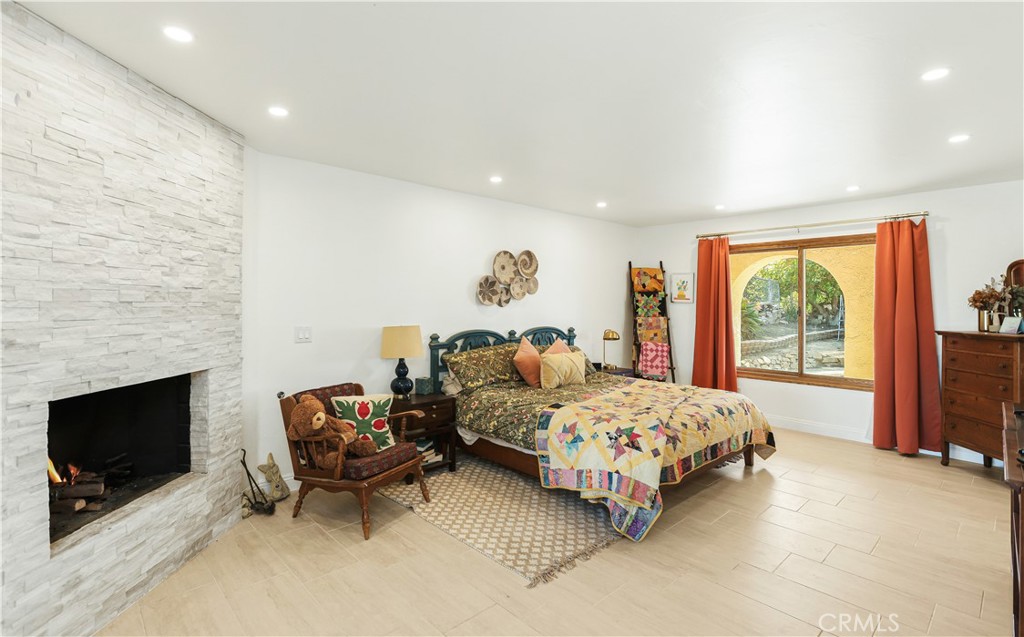 33532 Valle Road San Juan Capistrano, CA 92675 - Photo 23 of 60 a bedroom with bed and large windows