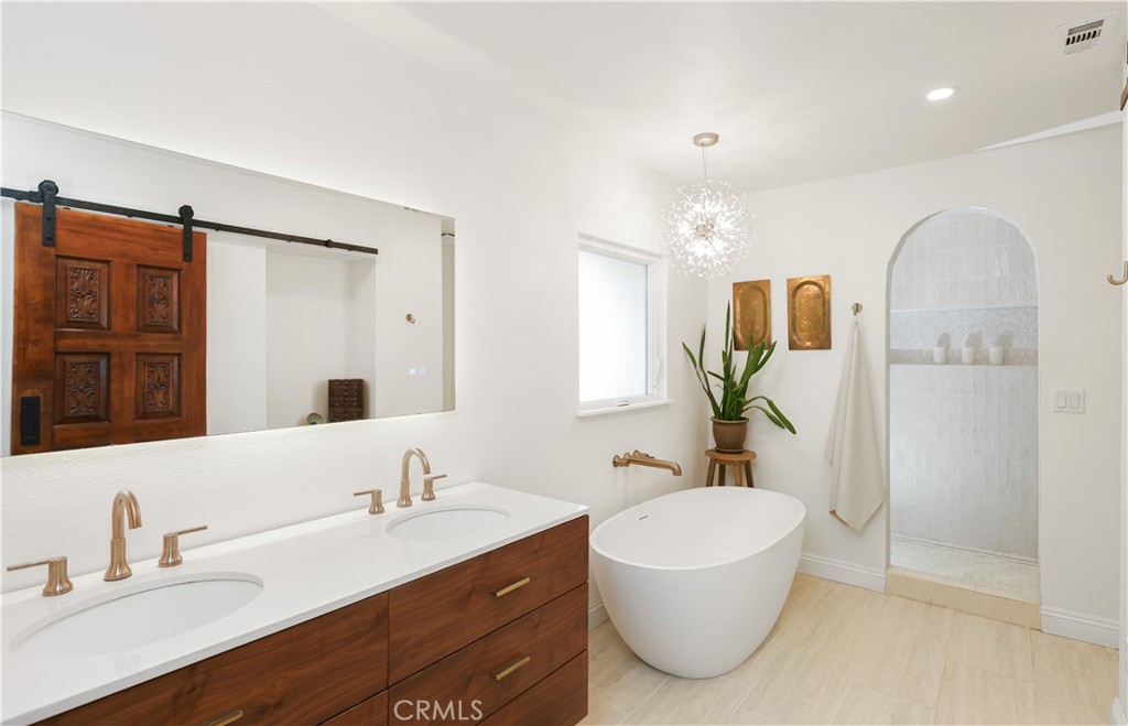 33532 Valle Road San Juan Capistrano, CA 92675 - Photo 27 of 60 a bathroom with a granite countertop sink mirror and bathtub