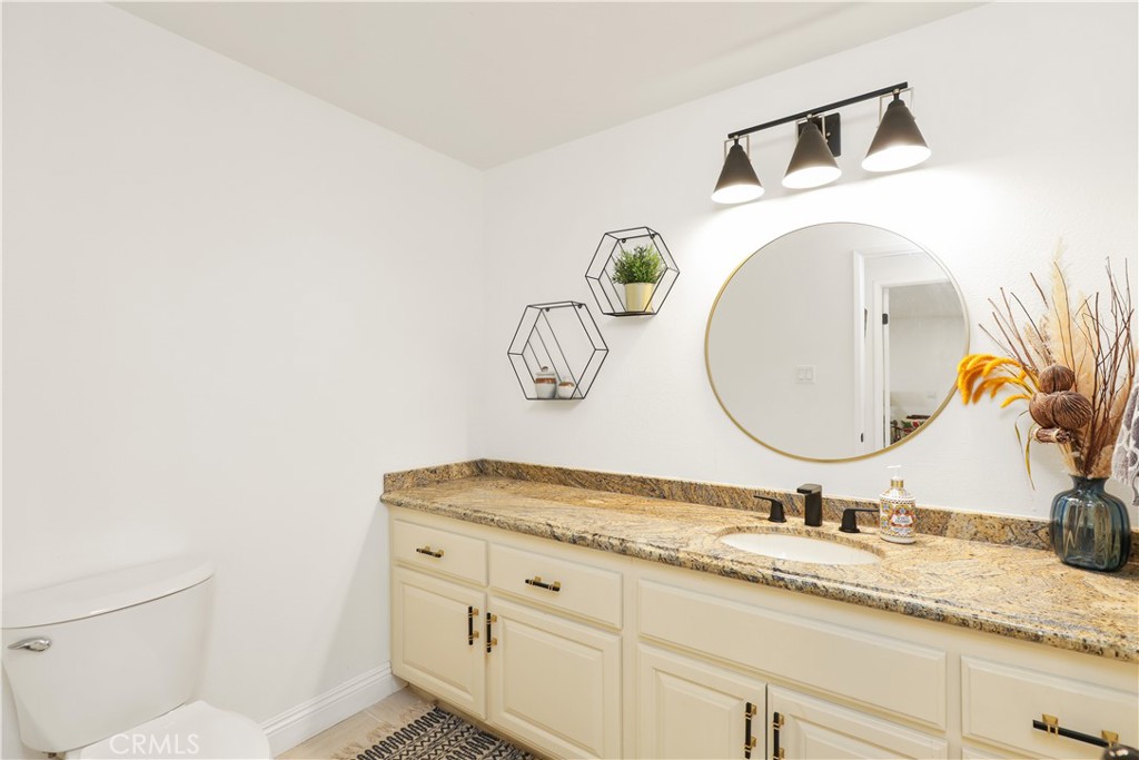 33532 Valle Road San Juan Capistrano, CA 92675 - Photo 29 of 60 a bathroom with a granite countertop sink and a mirror