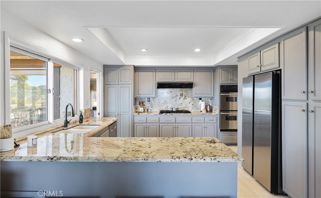 33532 Valle Road San Juan Capistrano, CA 92675 - Photo 37 of 60 a large kitchen with a large counter top and stainless steel appliances