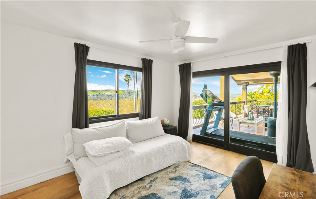 33532 Valle Road San Juan Capistrano, CA 92675 - Photo 47 of 60 a bedroom with a bed and glass window