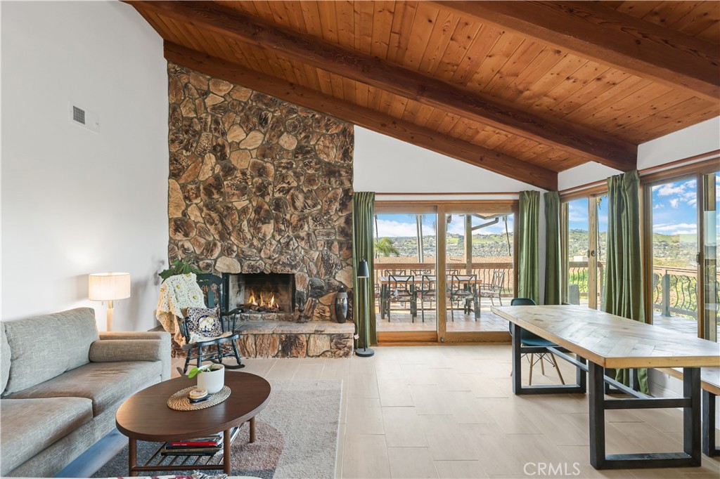 33532 Valle Road San Juan Capistrano, CA 92675 - Photo 53 of 60 a living room with furniture a fireplace and a table