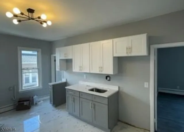 a kitchen with a sink cabinets and window