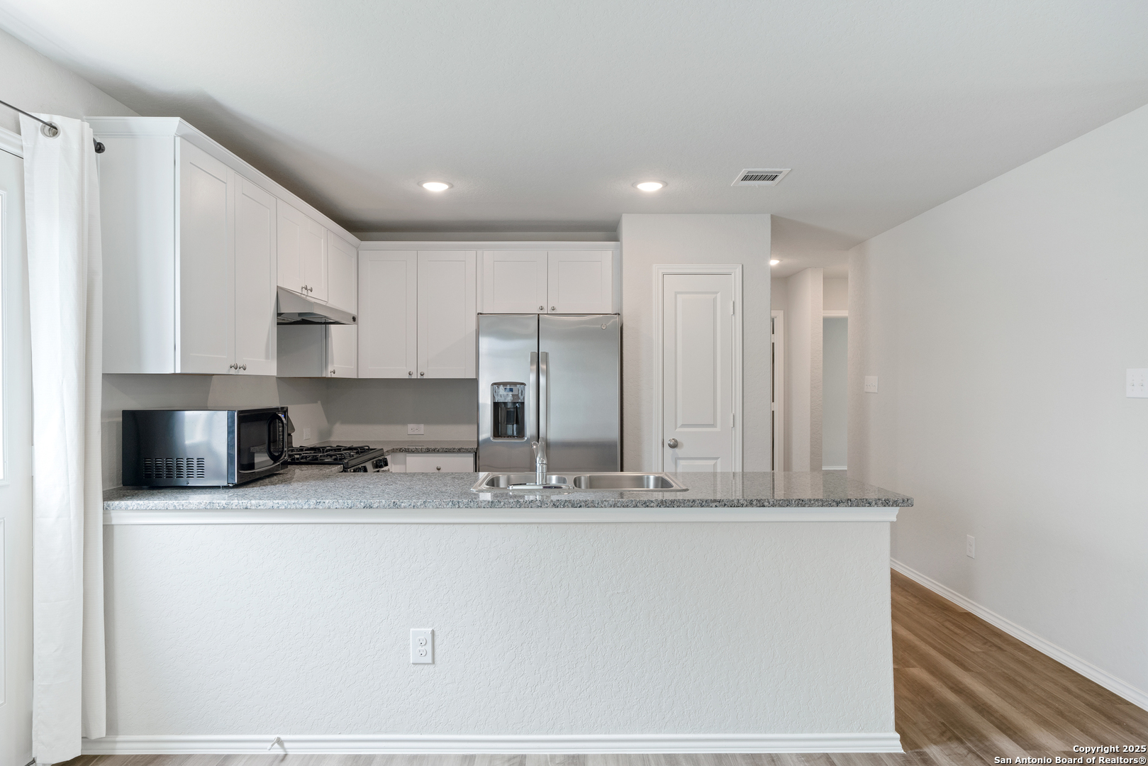 6534 Augustus Magee San Antonio, TX 78220 - Photo 11 of 25 a view of a kitchen with granite countertop cabinets