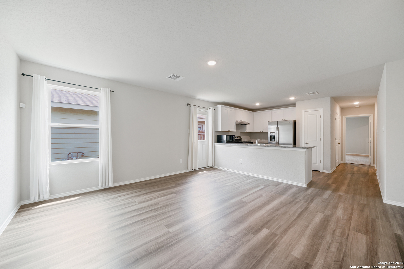 6534 Augustus Magee San Antonio, TX 78220 - Photo 13 of 25 a view of a kitchen with a sink and wooden floor