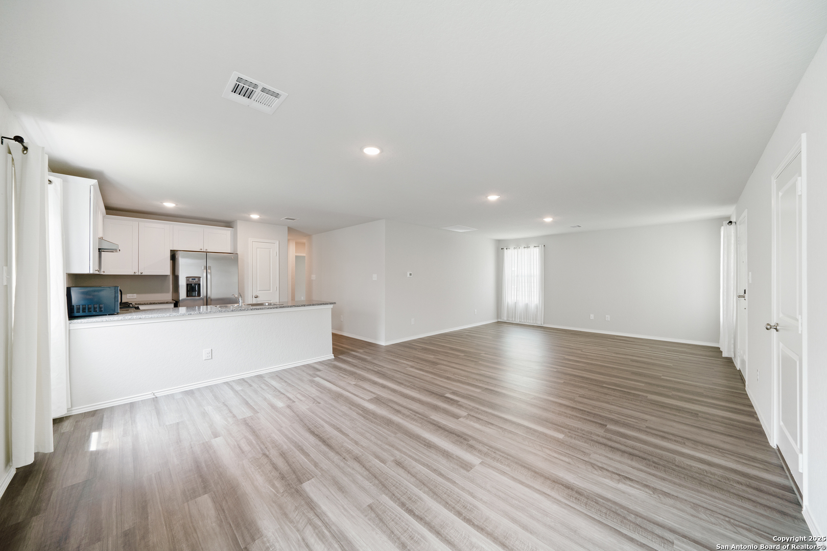 6534 Augustus Magee San Antonio, TX 78220 - Photo 14 of 25 a view of kitchen and kitchen with wooden floor