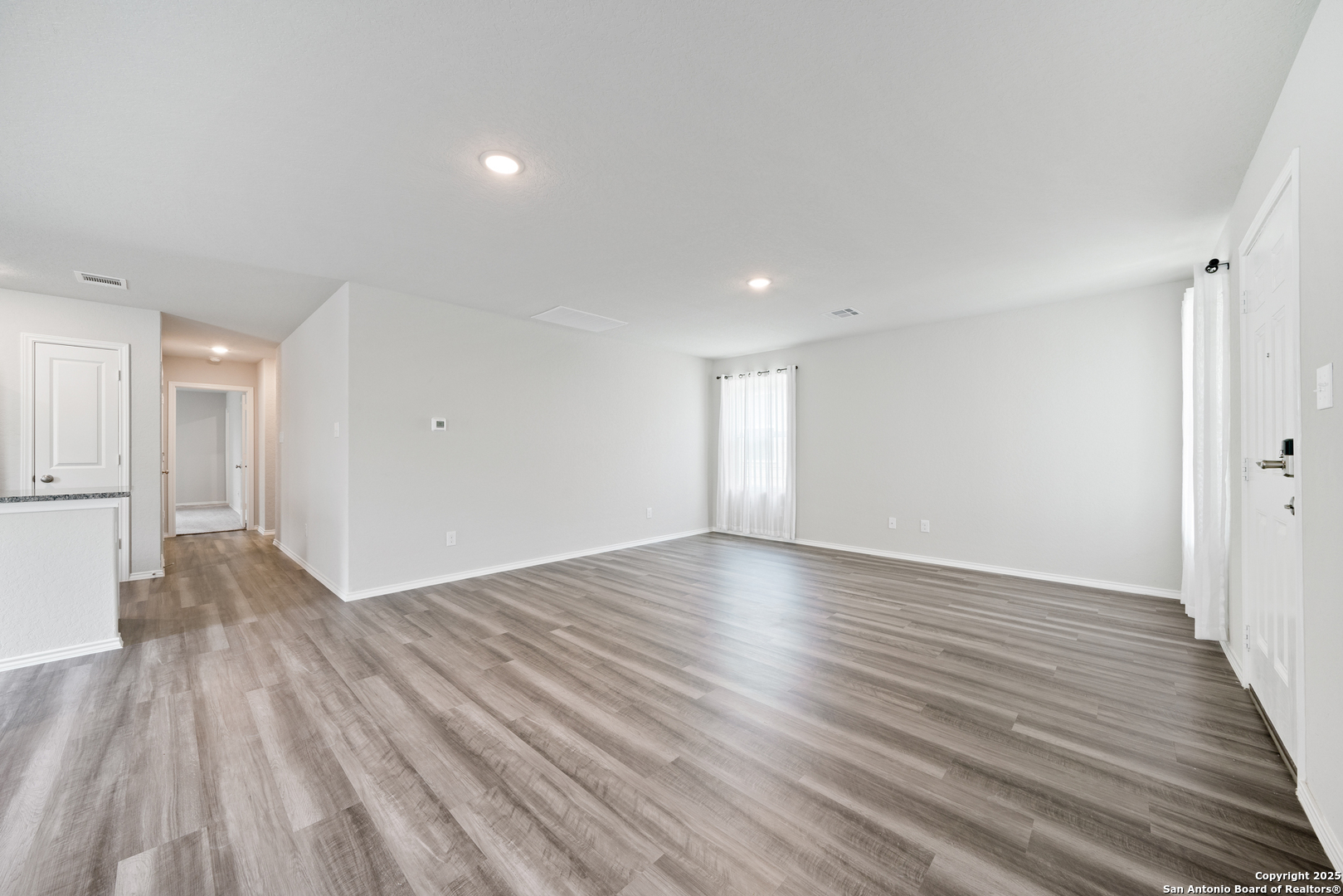 6534 Augustus Magee San Antonio, TX 78220 - Photo 6 of 25 a view of empty room with wooden floor