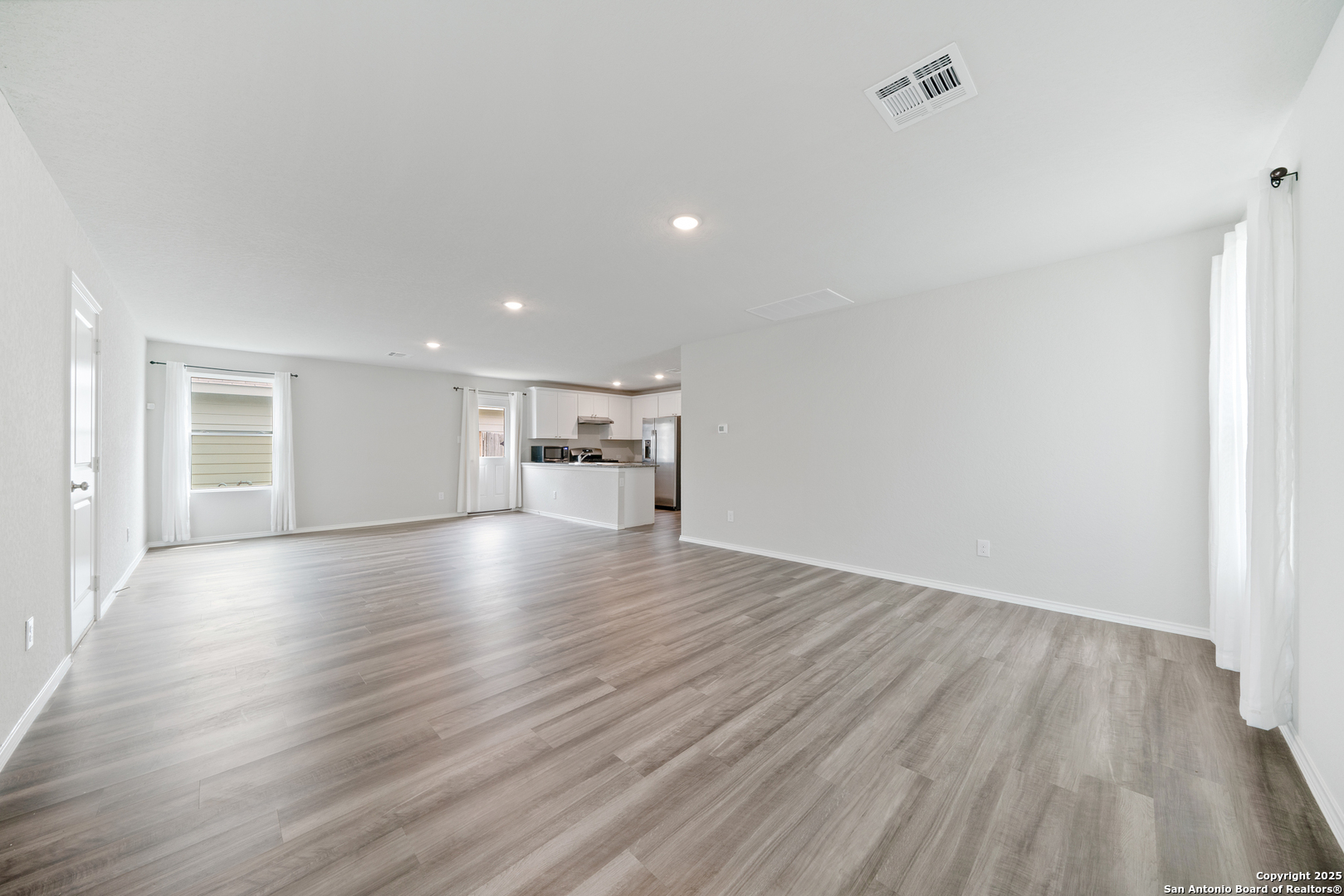 6534 Augustus Magee San Antonio, TX 78220 - Photo 7 of 25 a view of empty room with wooden floor