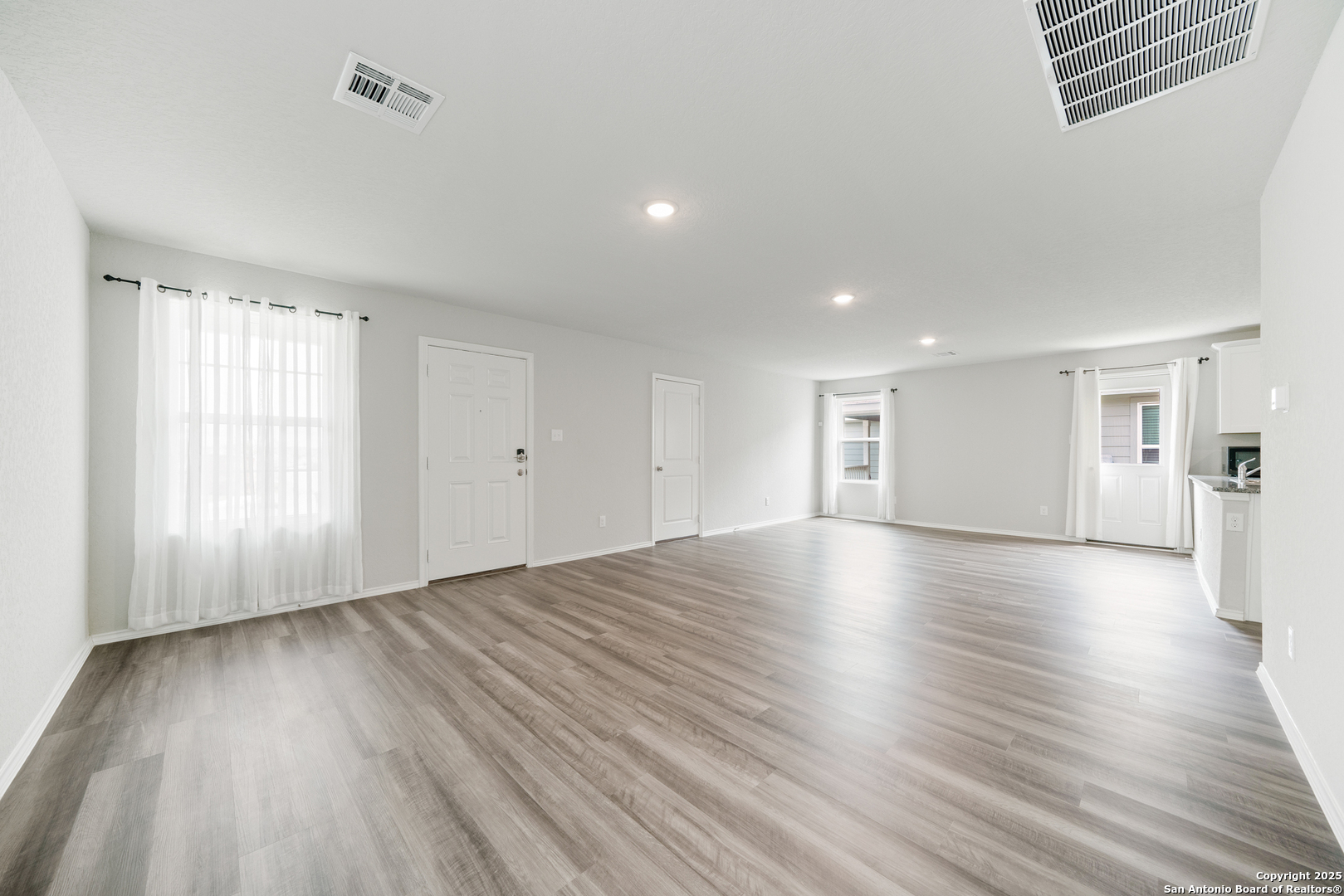 6534 Augustus Magee San Antonio, TX 78220 - Photo 8 of 25 an empty room with wooden floor and windows