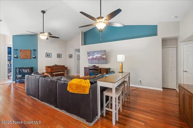a living room with furniture and a wooden floor