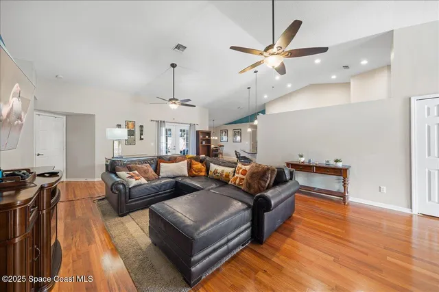 a kitchen with a stove a counter top space and a ceiling fan