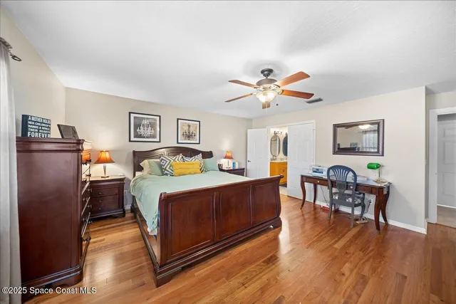 a bed room with a bed window and mirror